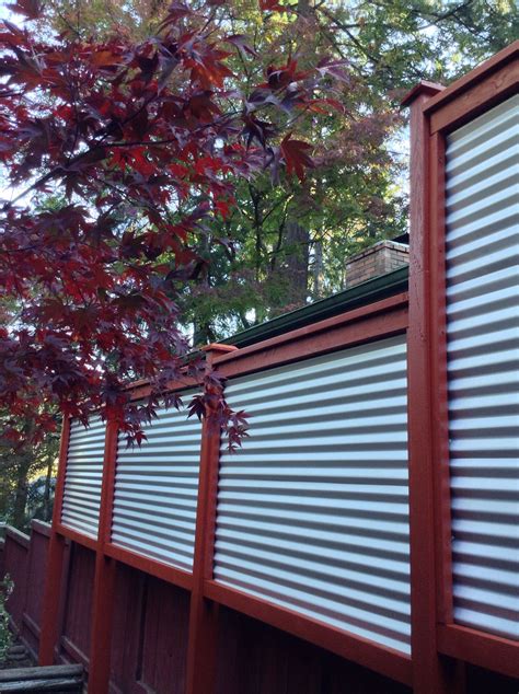 Using wide horizontal panels of corrugated metal, this fence relies on the dark wooden posts to stand strong. New corrugated metal fence for privacy screen between ...