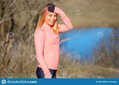 Portrait Of Young Runner Fitness Woman Standing Near The Pond Stock