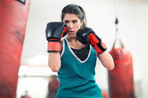 A Young Female Boxer Punching A Bag In The Gym Stock Photo Image Of