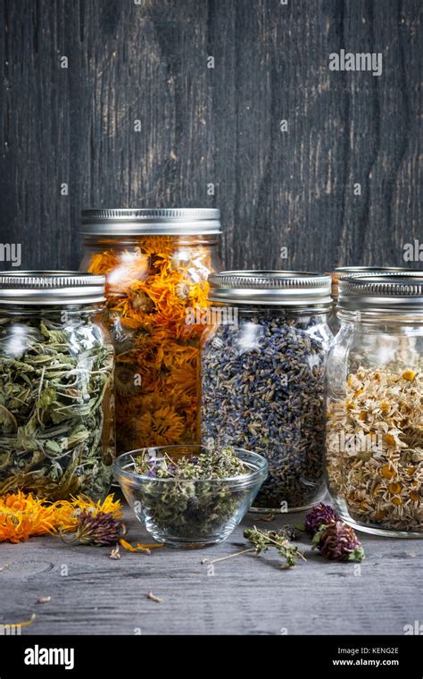Various Dried Medicinal Herbs And Herbal Teas In Several Glass Jars On