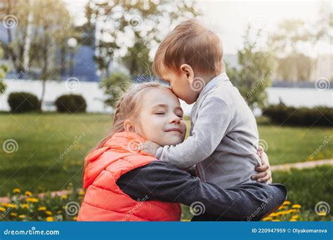 Older Sister Hugs Her Little Brother In Summer In The Park Stock Image Image Of Affectionate