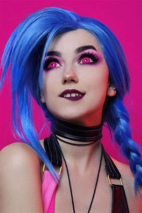 A Woman With Blue Hair And Pink Eyes Wearing Black Choker Necklaces