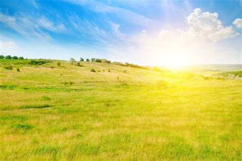 Hilly Green Fields And Sunrise On A Blue Sky Stock Photo Image Of