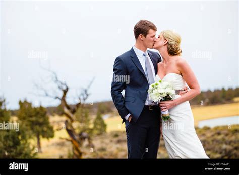 Bride And Groom Kissing Outdoors Stock Photo Alamy