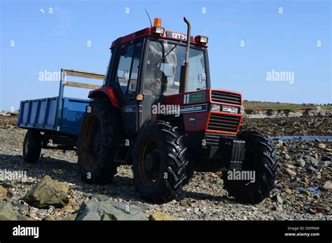 Tractor Crossing Causeway To Lihou Island On Guernsey Stock Photo Alamy
