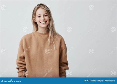 Cheerful Positive Female Youngster With Blonde Hair Dressed Casually