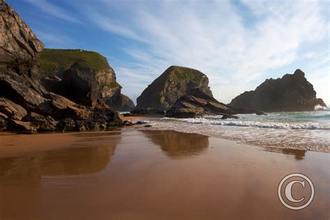 When you step on the sand, you compress them, reducing the space between the sand particles. Reflections of rock formations in the wet sand at ...