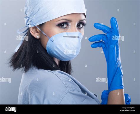 Female Nurse Doctor Surgeon Wearing Scrubs With Gloves And Mask