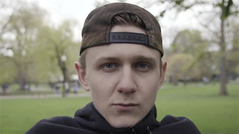 Push In To Close Of Young Man Sitting On Park Bench Slow Motion Clipstock