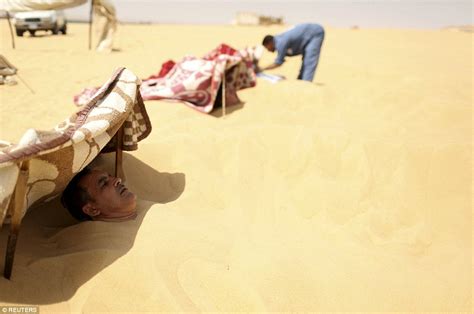 Egyptians Bury Themselves Up To Their Necks For Desert Sand Baths