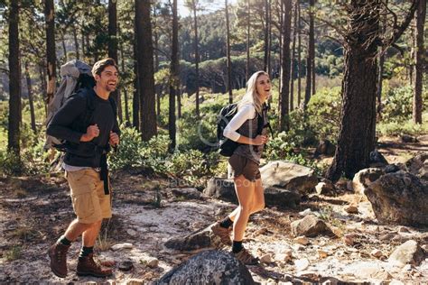 Hiking Couple Walking In Forest Wearing Backpacks Jacob Lund Photography Store Premium Stock