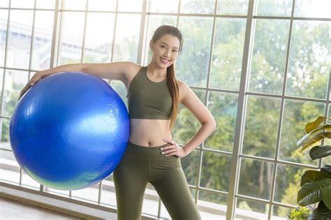 Fit Young Women Exercising With Fitness Ball At Home Sport And Healthy