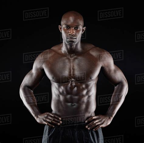 Portrait Of A Strong Afro American Man Showing Off His Physique Against
