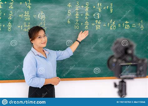 Asian Primary Teacher Tutor Explaining Math In Blackboard Giving Remote