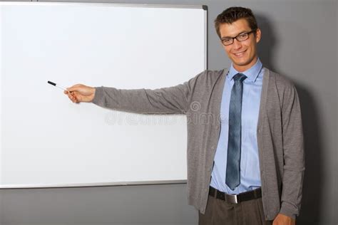 Portrait Of Businessman Pointing At Whiteboard In Office Stock Photo