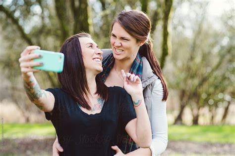 Cute Lesbian Couple Taking A Selfie In The Park By Stocksy Contributor Kate Ames Stocksy