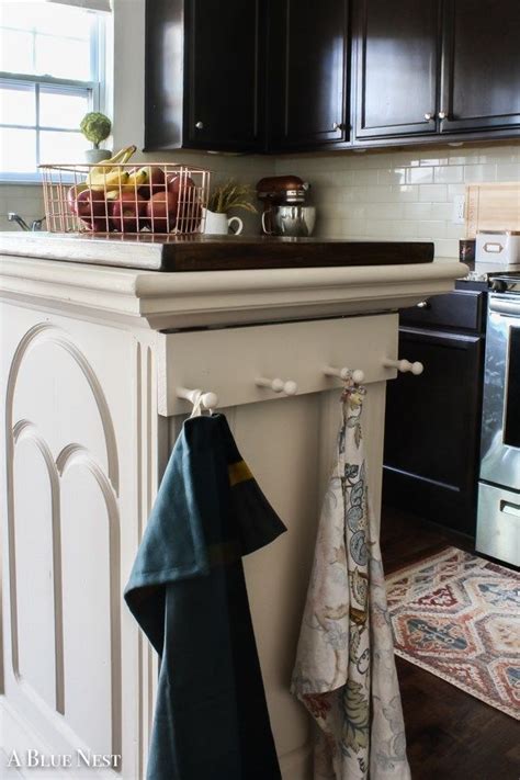 It has four stylish doors on the front that open to reveal spacious cabinets with adjustable inner shelves as well as two drawers where you can store utensils and other cooking supplies. DIY Kitchen Island Makeover - A Blue Nest | Kitchen island ...