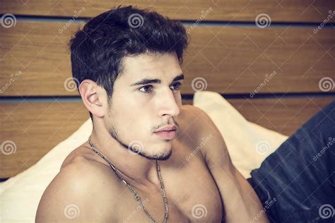 shirtless male model lying alone on his bed stock image image of attractive appealing 62829937