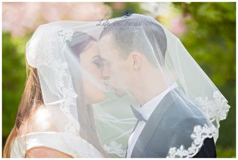 Bride And Groom Kiss Under Wedding Veil Life In Focus Portraits Wedding Photographer