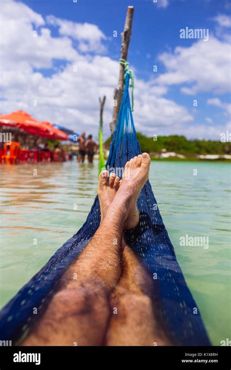 Legs And Feet Of A Man Laid On A Hammock In A Lake Ocean Sea Lagoa Azul Jericoacoara Ceará