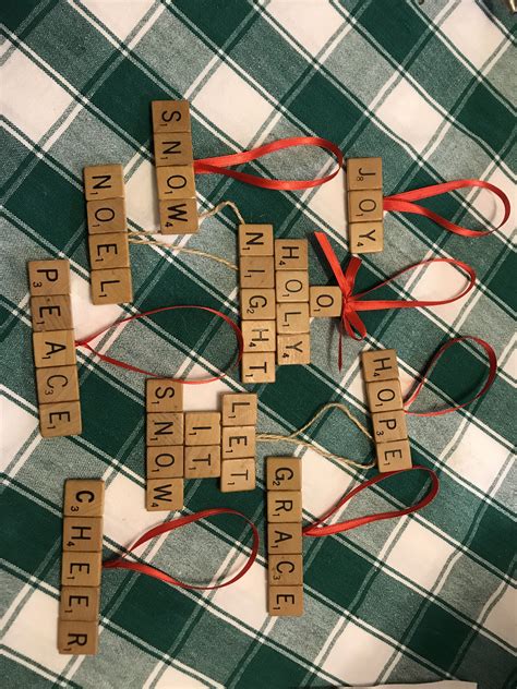 Wooden Scrabbles Spelling Out Words On A Green And White Checkered Blanket