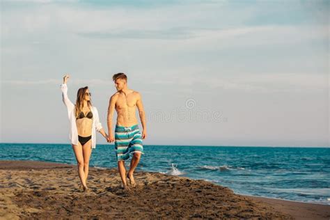 4109 Happy Young Couple Walking Holding Hands Beach Photos Free