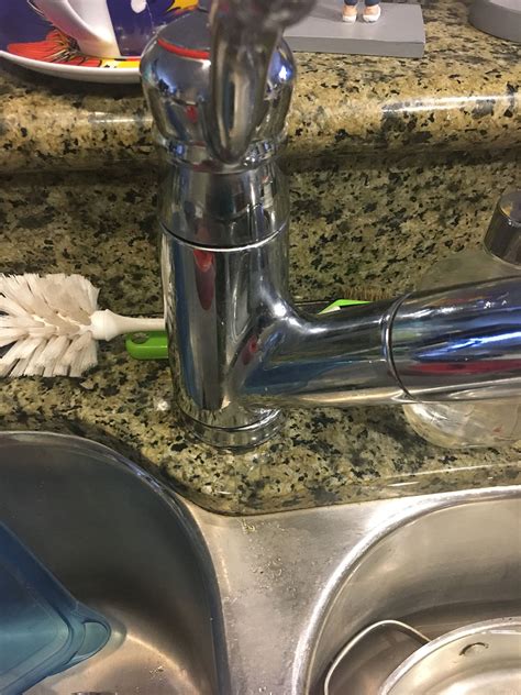 Shut off the water at the valves below the sink, then flip off the plastic disc that has h or c on it. How To Tighten Kitchen Faucet Under Sink | Kitchen Faucets