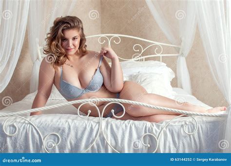 Plus Size Playful Girl Lying In Bed Stock Photo Image