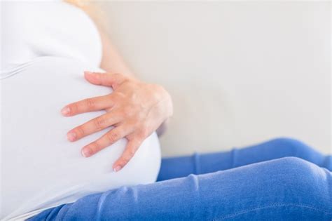 Premium Photo Close Up Of Pregnant Woman With One Hand On Belly