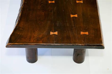 Technically you do weaken the leg slightly, but with a tight fitting joint and a solid wood shelf filling the gap you have cut out, the weakening is negligible. Live Edge Coffee Table with Butterfly Joint Detail For Sale at 1stdibs