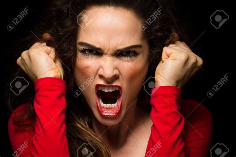 A Very Angry Aggressive Woman Is Clenching Her Fists In Rage Very