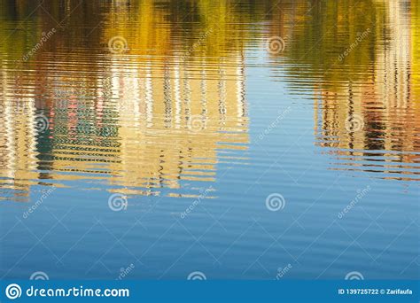 Reflection Of Buildings And Trees In Water River Pond Lake In Autumn