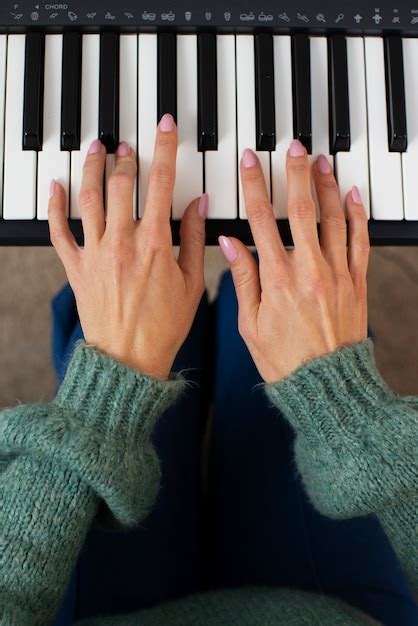 Premium Photo | Hands playing piano top view