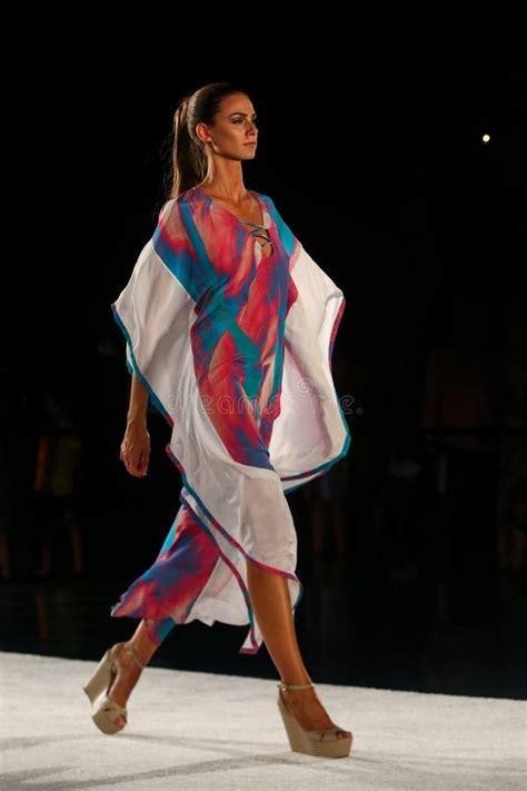A Model Walks Runway In Designer Swim Apparel During The Caffe Swimwear