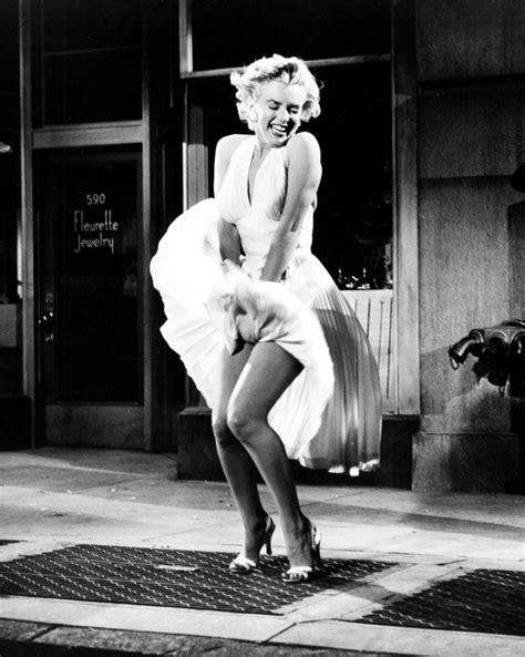 Marilyn Monroe Dancing On The Sidewalk In Front Of A Building