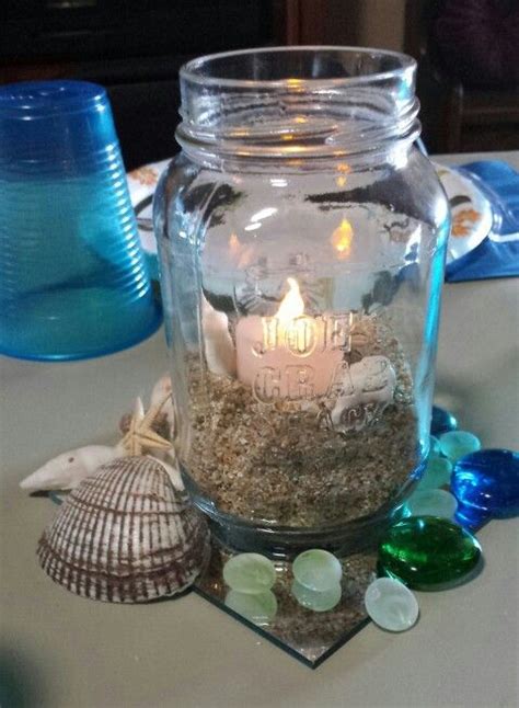 So, a beach wedding table décor should be special, add some pretty sea life to the tables and centerpieces: I have these blue mason jars...and sand. Many bags of sand ...