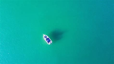 2048x1152 Boat In Blue Sea Water 2048x1152 Resolution Wallpaper Hd