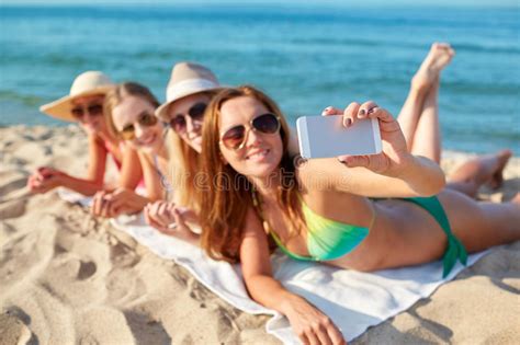 Close Up Of Smiling Women With Smartphone On Beach Stock Photo Image