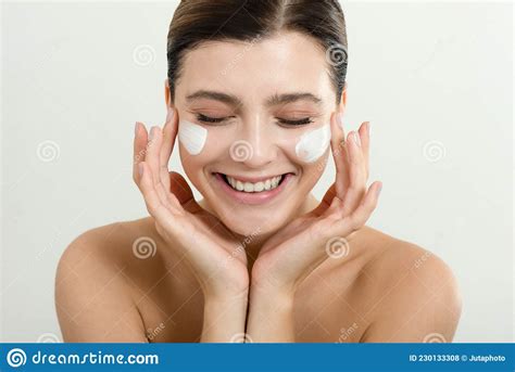 Young Woman Applying Face Cream On Her Face Beauty Model With Perfect