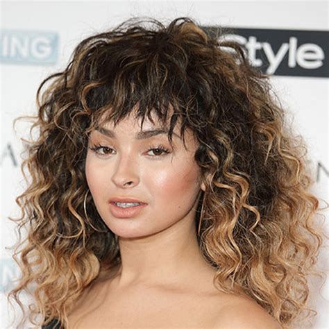 A curly hair texture paired with a short fringe helps soften face shapes and draws attention to the eyes. How to Style Curly Bangs Without Looking Like a Flashdance ...