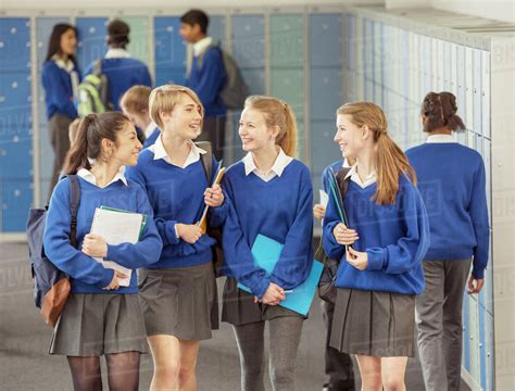 Cheerful Female Students Wearing Blue School Uniforms Walking In Locker