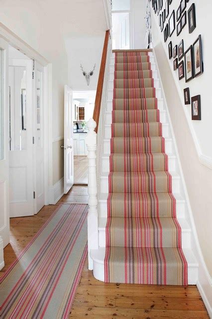 Foyer rug next to leaded glass window alongside wood floor stairs and wooden staircase. 21 Ways To Refresh Your Hallway Design Ideas
