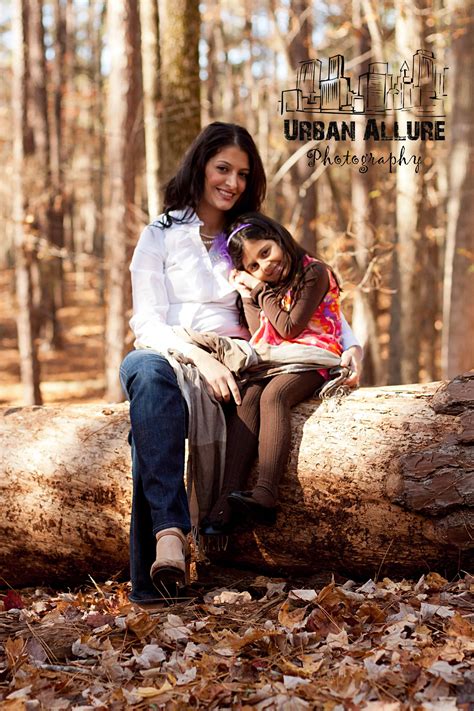 Pose Of Mother An Daughter Love The Sitting On A Log In The Woods