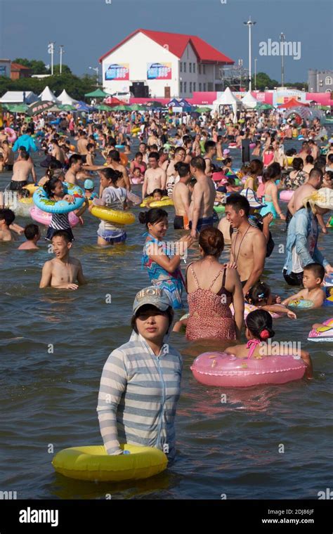 Chinese Tourists Enjoy An Artificial Beach At The Bihai Jinsha Beach In Fengxian District