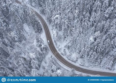 Snowy Winding Curving Mountain Road With Moving Car During Snowfall