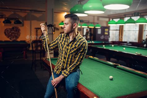Male Billiard Player With Cue Poses At The Table Stock Photo By NomadSoul1