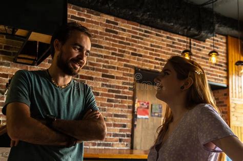 Smiling Young Couple Standing In Cozy Bar And Talking Each Other Stock Image Image Of Cheerful