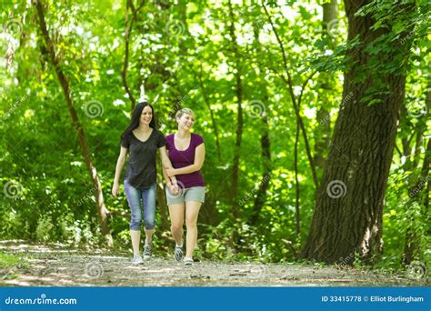 Girlfriends Taking A Walk Through The Park Horizontal Stock Photo