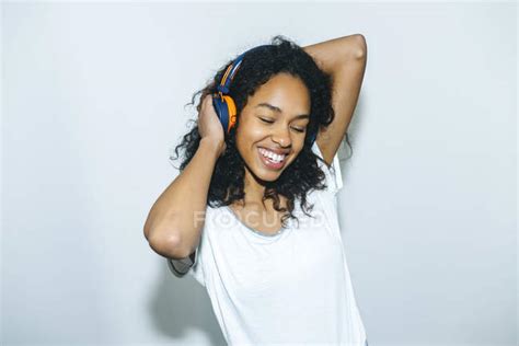 Portrait Of Happy Young Woman Listening Music With Headphones — High