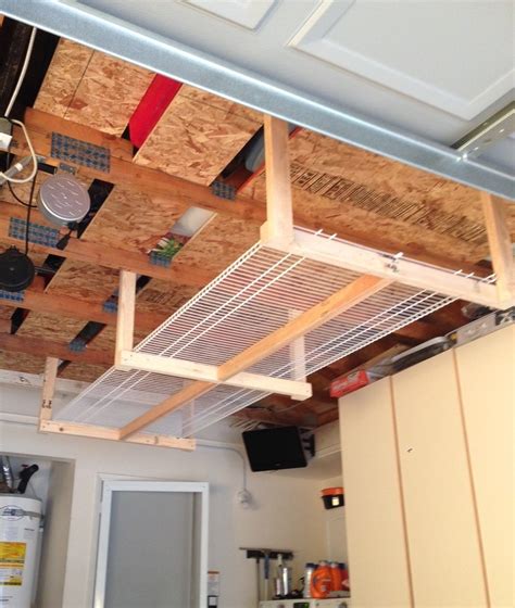 Garage ceiling storage racks are handy in storing away items we use in a garage regularly or keep the items out of sight that we use seasonally. DIY overhead garage storage rack...four 2x3's, and two 8 ...